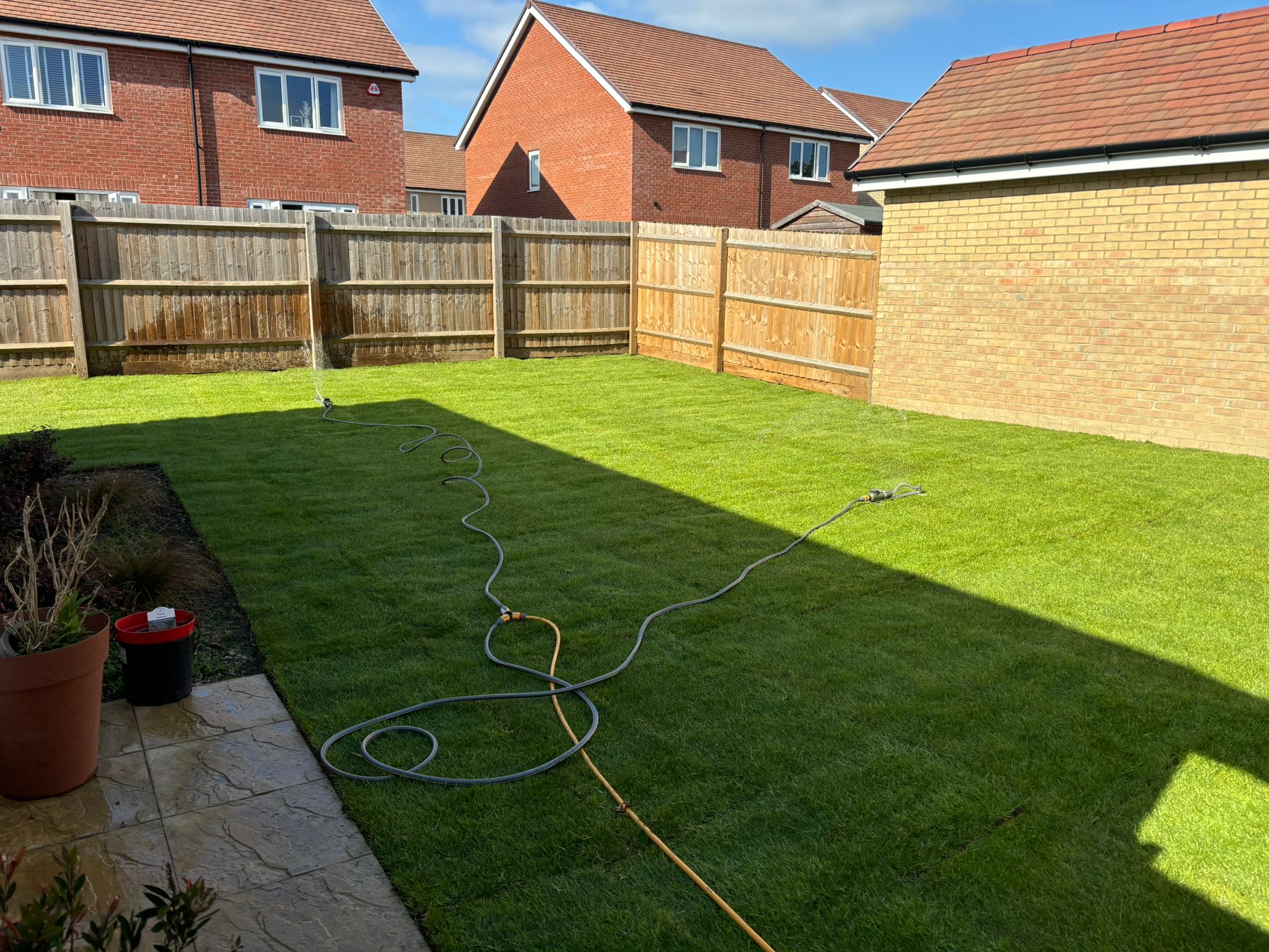Completed artificial grass installation with new fencing